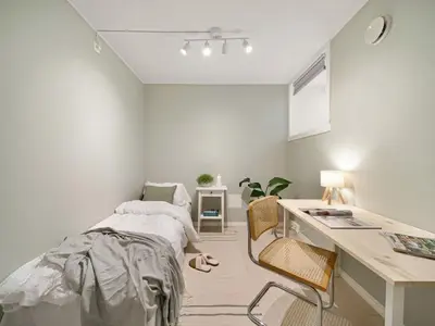 a white bedroom with a bed and a desk at Stor leilighet i Bergen sentrum! in Bergen