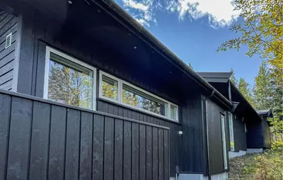 a black house with two windows on the side of it at Stunning Home In Trysil With Sauna in Trysil