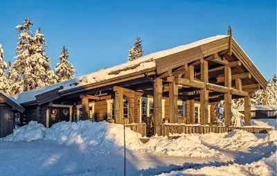 a log cabin in the snow with snow at Awesome Home In Sjusjøen With Sauna in Sjusjøen