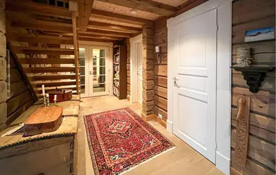 a hallway of a house with a rug and a door at Awesome Home In Sjusjøen With Sauna in Sjusjøen
