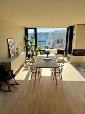 a large living room with a table and chairs at Unik funkisbolig leies ut til ski-VM in Lund