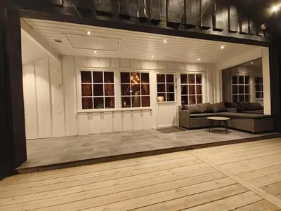 a living room with a couch and a table at OlaHytta - Cozy cabin close to kvitfjell in Tromsnes
