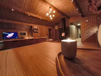 a living room with a table and a tv at OlaHytta - Cozy cabin close to kvitfjell in Tromsnes