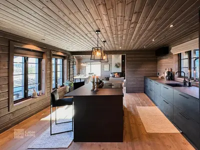 a kitchen with a large island in the middle at Modern cabin at Høgevarde panoramic view, fireplace and EV station in Granheim