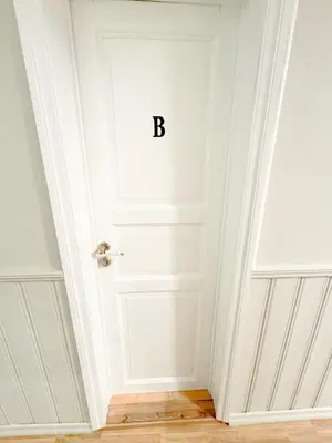 a white door with the letter b on it at Central stay apartment - 301 in Bergen