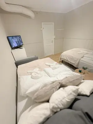 a bedroom with two beds and a laptop on a desk at Central stay apartment - 301 in Bergen