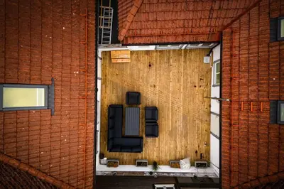 an outdoor patio with two chairs on a building at Central stay apartment - 301 in Bergen