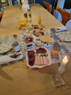 a table with food and a candle on it at Brygga B&B Trondheim sentrum, privat rom i vårt hjem in Trondheim