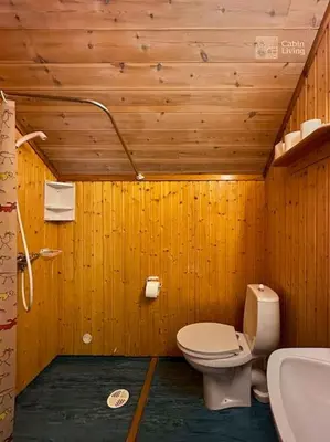 a wooden bathroom with a toilet and a sink at Original Olympic cabin ski in out Hafjell in Hunder