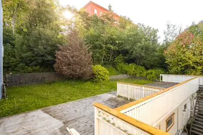 a view of a garden from the balcony of a house at Super Central renovated flat, next to Solsiden, Free Private Parking right outside ! in Trondheim
