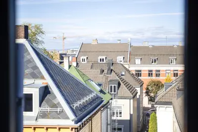 a view of a group of roofs with buildings at Super Central renovated flat, next to Solsiden, Free Private Parking right outside ! in Trondheim