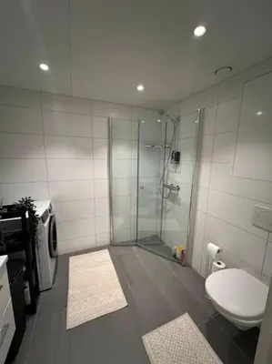 a bathroom with a glass shower and a toilet at SKI VM - Trondheim 2025 in Heimdal