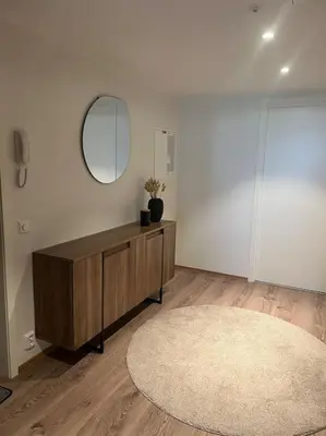 a room with a table and a mirror and a rug at SKI VM - Trondheim 2025 in Heimdal