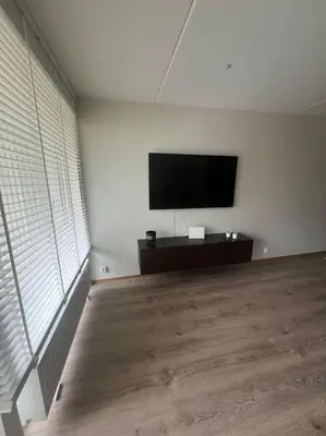 a living room with a flat screen tv on a wall at SKI VM - Trondheim 2025 in Heimdal