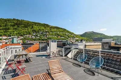 a group of chairs sitting on top of a roof at Cozy studio in Bergen center in Bergen