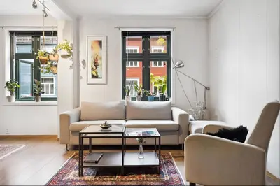 a living room with a couch and a table at Stylish & Modern Apartment, in Centre, Free Parking spot ! in Trondheim