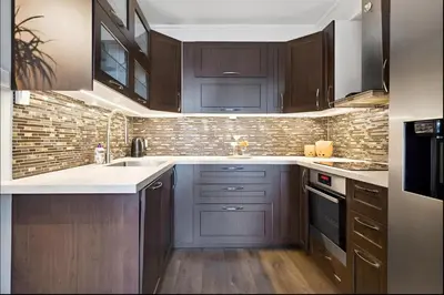 a kitchen with dark wood cabinets and a sink at Stylish & Modern Apartment, in Centre, Free Parking spot ! in Trondheim