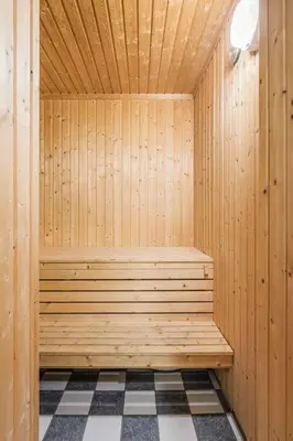 a wooden sauna with a checkered floor at Leilighet sentralt i Trysil in Hovi