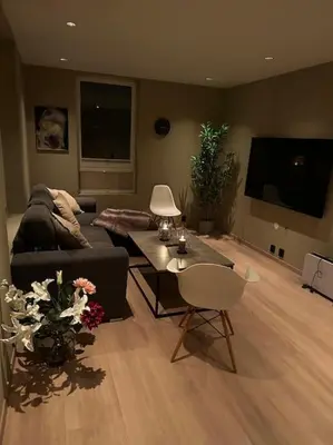 a living room with a couch and a table at Enebolig Trondheim, familievennlig, nytt 2023 in Trondheim