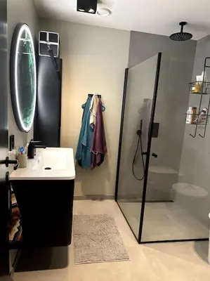 a bathroom with a shower and a sink and a mirror at Enebolig Trondheim, familievennlig, nytt 2023 in Trondheim