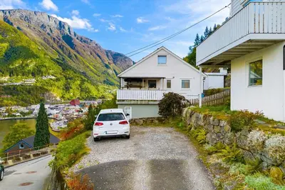 a white car parked in front of a house at Trolltunga Fjord View in Tokheim