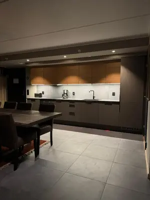 a large kitchen with a wooden table and a counter at Chalet Chablis in Hemsedal