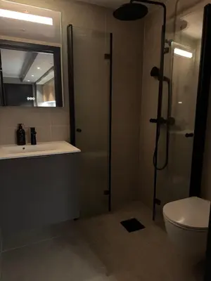 a bathroom with a shower and a sink and a toilet at Chalet Chablis in Hemsedal