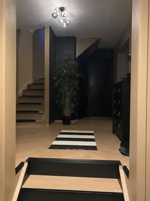 a hallway with a staircase and a potted plant at Totalrenovert enebolig i rolige omgivelser in Trondheim