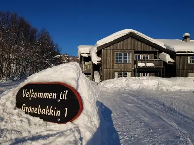 a sign in the snow in front of a house at Cozy 3 Bedroom, Terrace, Pets Welcome in Beitostøl
