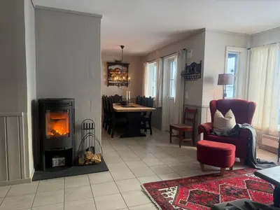 a living room with a fireplace and a dining room at Cozy 3 Bedroom, Terrace, Pets Welcome in Beitostøl