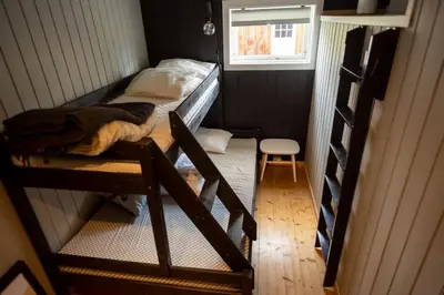 a small room with two bunk beds and a ladder at Cozy apartment close to the ski resort in Oppdal
