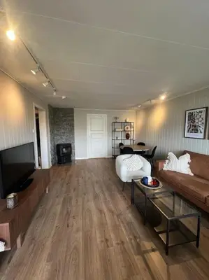 a living room with a couch and a tv at Bolig til leie under ski-VM 2025 in Trondheim
