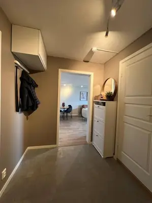 a kitchen with a hallway with a sink and a door at Bolig til leie under ski-VM 2025 in Trondheim