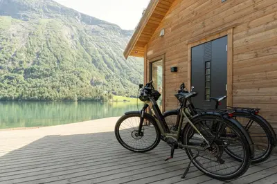 two bikes parked on a wooden deck near a lake at Tenden Panorama in Stryn