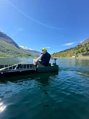 a man sitting on a boat on a lake at Tenden Panorama in Stryn