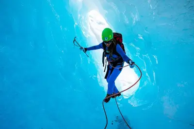 a person in the water with a backpack and a dolphin at Odda Trolltunga Atmosphere in Odda