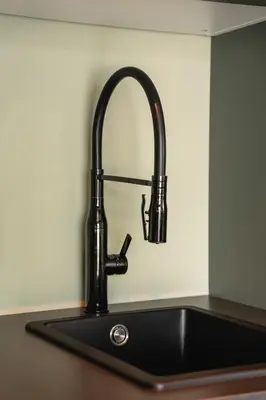 a kitchen sink with a faucet on a counter at Odda Trolltunga Atmosphere in Odda