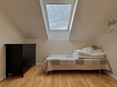 a bedroom with a bed and a window at Beautiful penthouse centrally located in Geilo, stunning views in Geilo