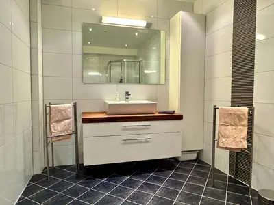 a bathroom with a sink and a mirror at Beautiful penthouse centrally located in Geilo, stunning views in Geilo