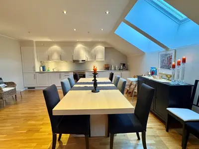 a dining room and kitchen with a table and chairs at Beautiful penthouse centrally located in Geilo, stunning views in Geilo
