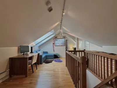 a room with a desk and a computer in a attic at Beautiful penthouse centrally located in Geilo, stunning views in Geilo