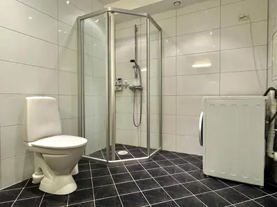 a bathroom with a toilet and a glass shower at Beautiful penthouse centrally located in Geilo, stunning views in Geilo