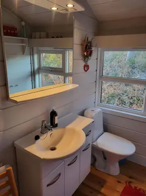 a bathroom with a sink and a toilet at Cabin on an beautiful island with a sea view in Vinsternes