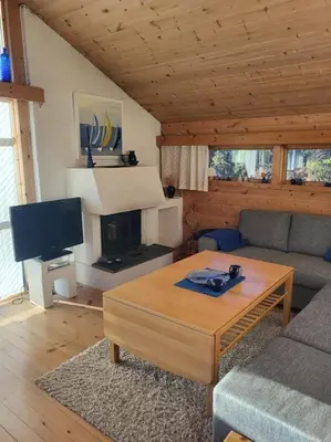 a living room with a couch and a coffee table at Cabin on an beautiful island with a sea view in Vinsternes