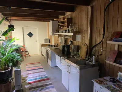 a kitchen with a sink and a counter top at Ner-Grefstad gard in Kallstad