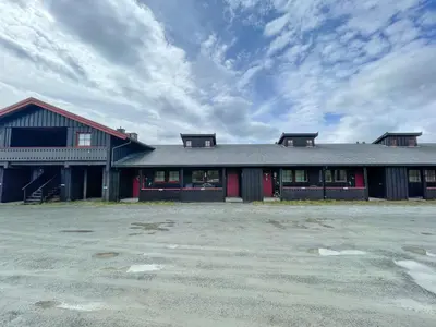 a large building with a parking lot in front of it at Perfect Retreat For Small Families in Beitostøl