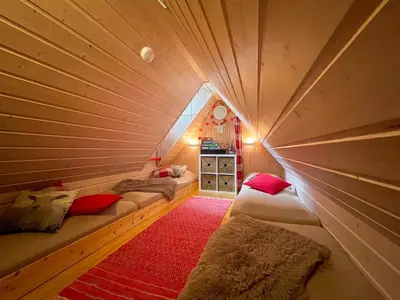 a room with three beds in a wooden room at Perfect Retreat For Small Families in Beitostøl