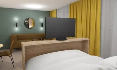 a bedroom with a bed and a flat screen tv at Thon Hotel Straume in Straume