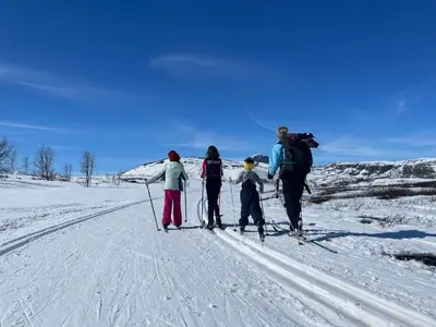 a group of people on skis in the snow at Charming Family Cabin With Stunning Mountain Views in Beitostøl