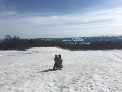 two children standing on a snow covered slope at Charming Family Cabin With Stunning Mountain Views in Beitostøl